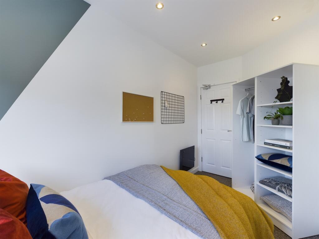 A bright and inviting double bedroom featuring ...