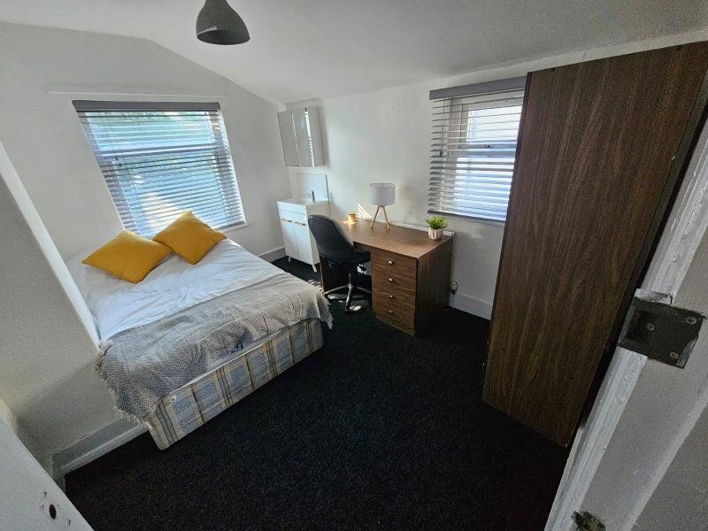 Bright and cozy double bedroom featuring a comf...