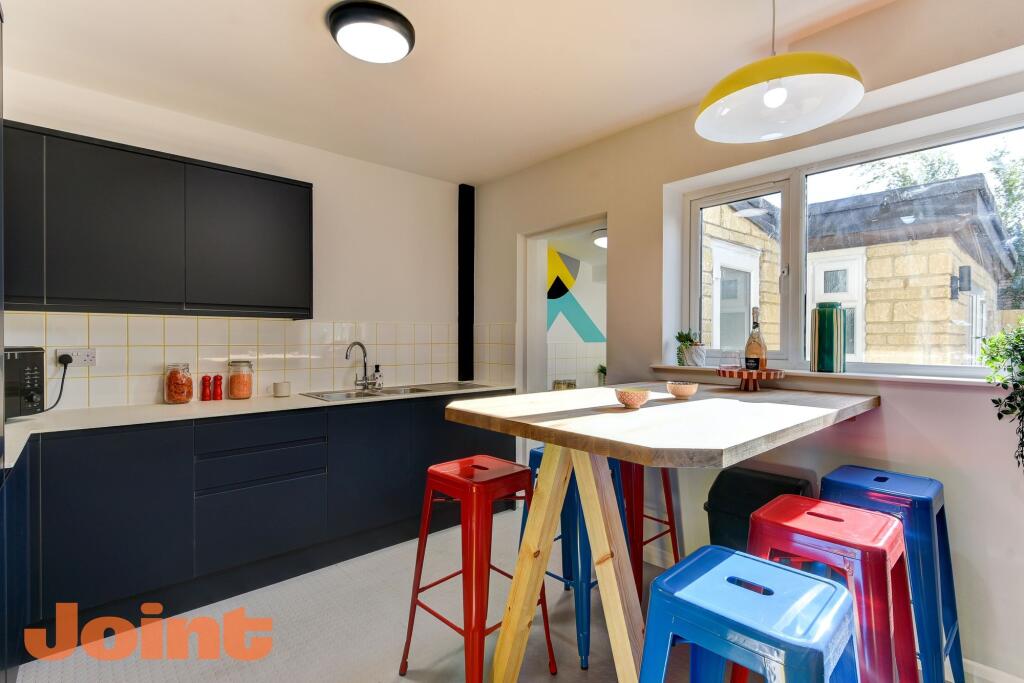 Modern kitchen featuring sleek cabinetry and vi...