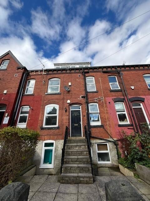 Victorian red-brick terraced house with raised ...
