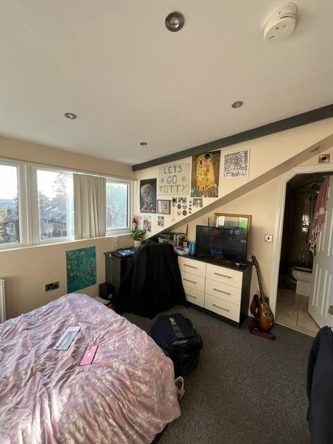 Bright and characterful bedroom with a large wi...