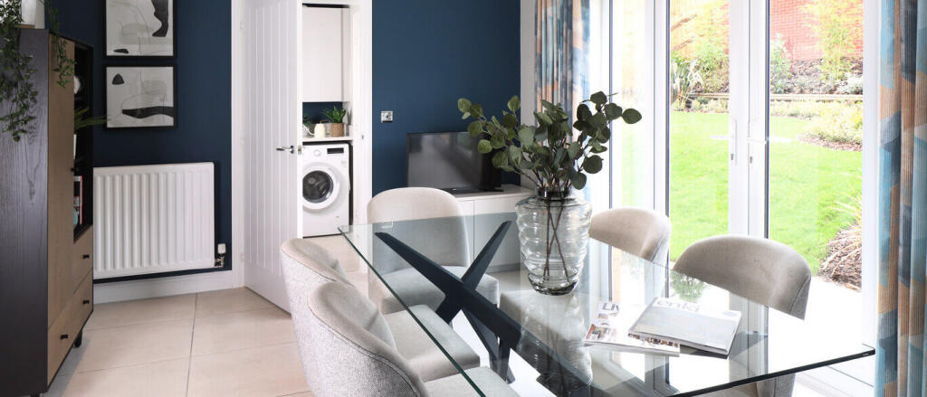 Modern dining area with glass table, six cream chairs, large window with colourful curtains, and a v