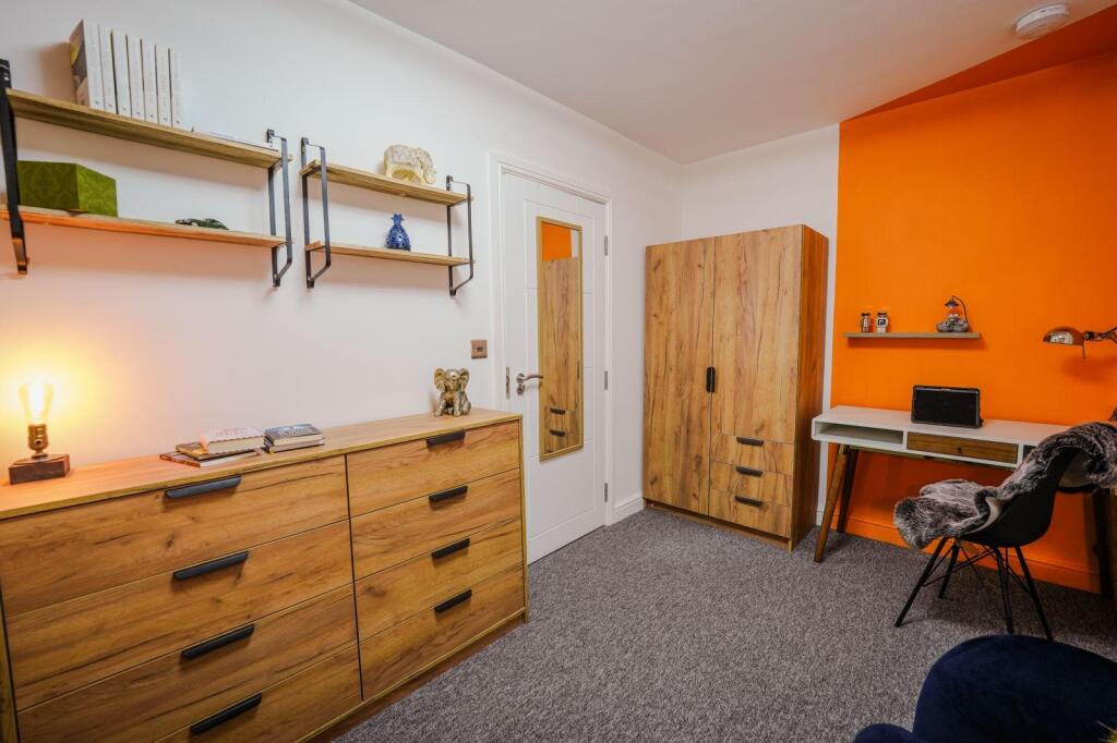 Bright and modern single bedroom featuring styl...