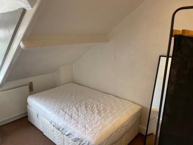 Cozy double bedroom featuring a comfortable dou...