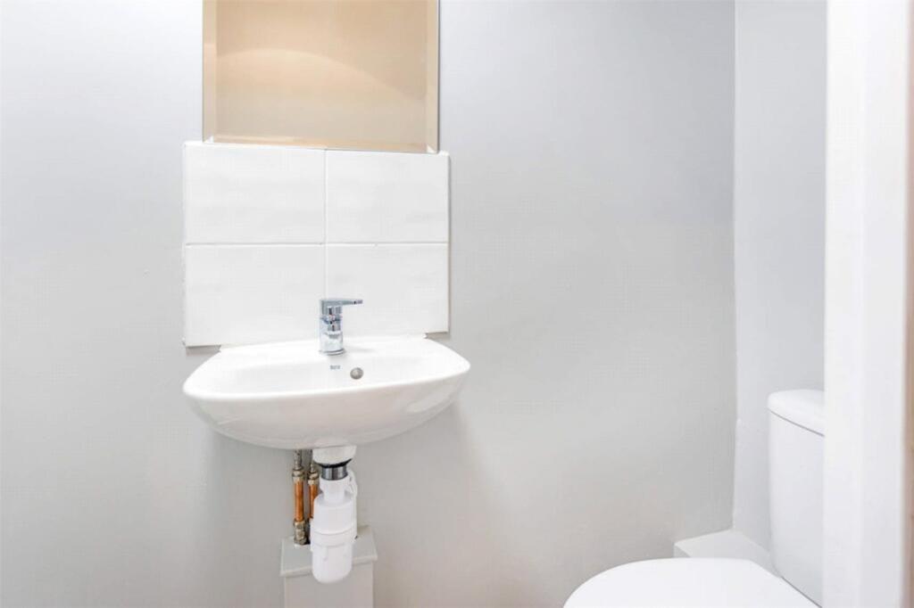 A well-maintained single toilet featuring moder...