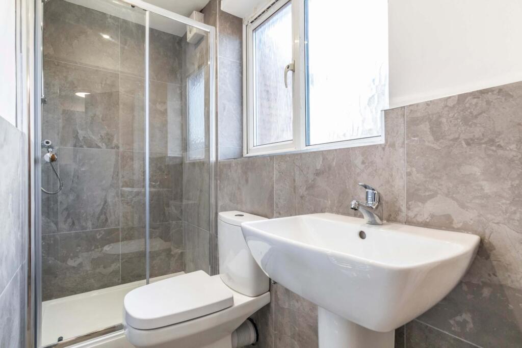 Modern bathroom with a walk-in shower, pedestal...