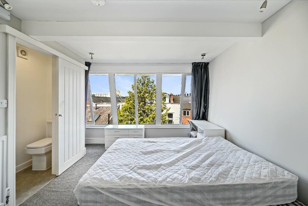 Bright and tidy double bedroom featuring a larg...