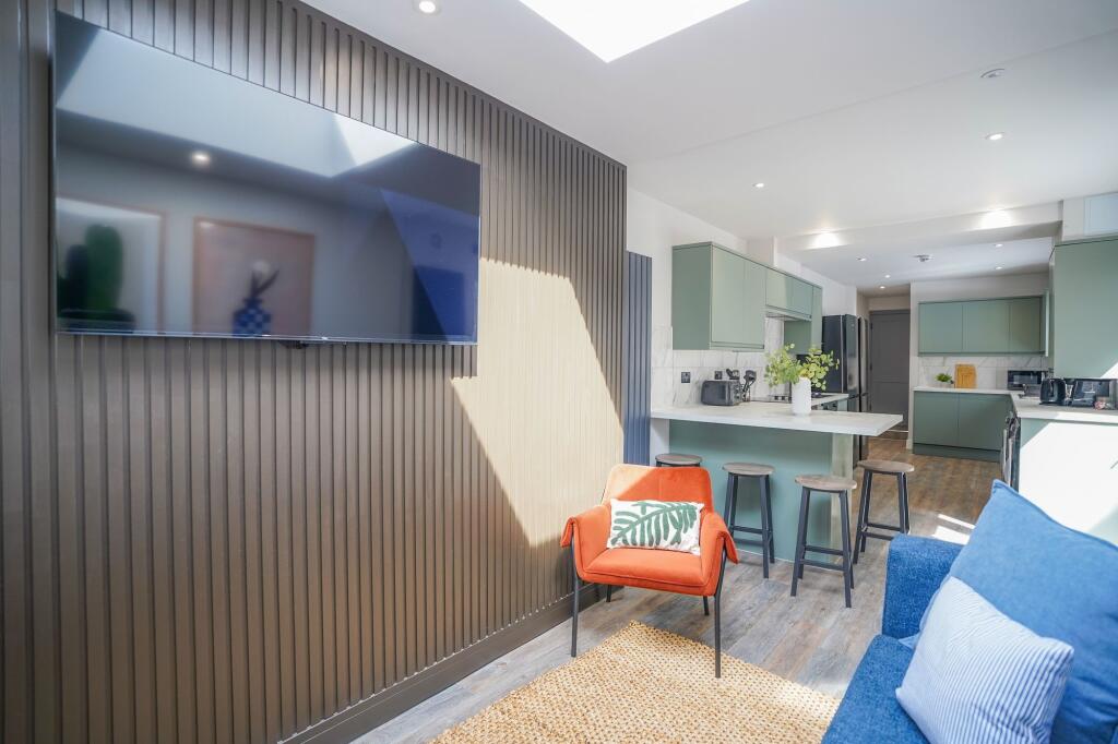 A modern, bright living room featuring a vibran...