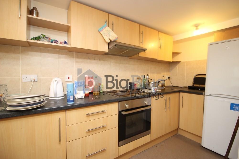 A well-organized kitchen with light wood cabine...