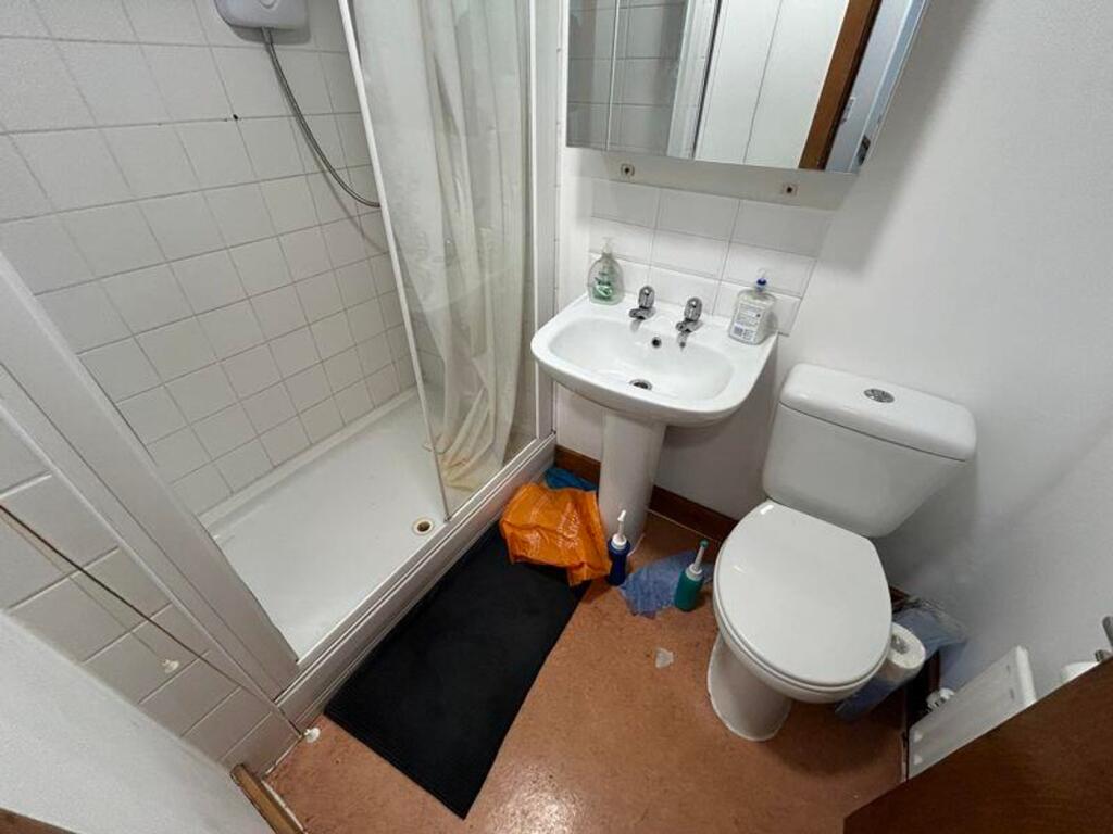 A functional bathroom featuring a shower, sink,...