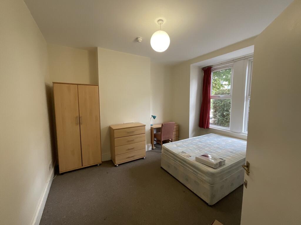 A bright and inviting double bedroom featuring ...