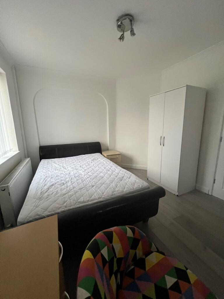 A bright and spacious double bedroom featuring ...