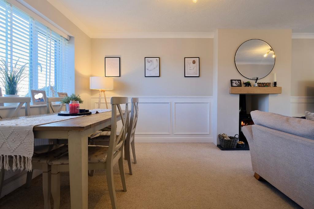 Dining area in sitting room, log burner