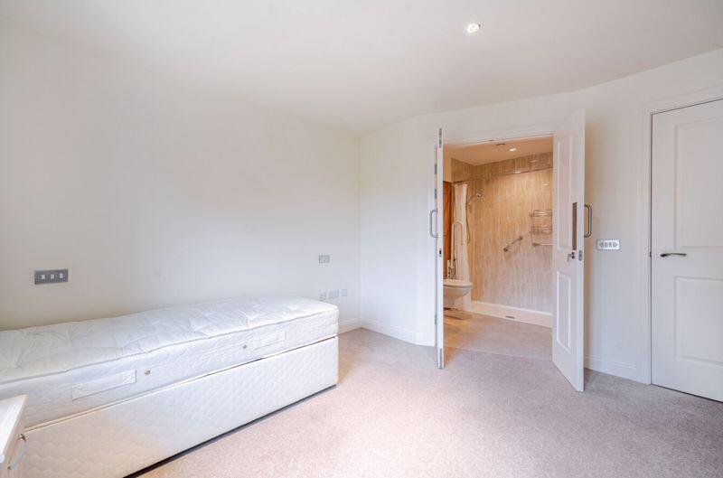 Bedroom with fitted wardrobes and ens...