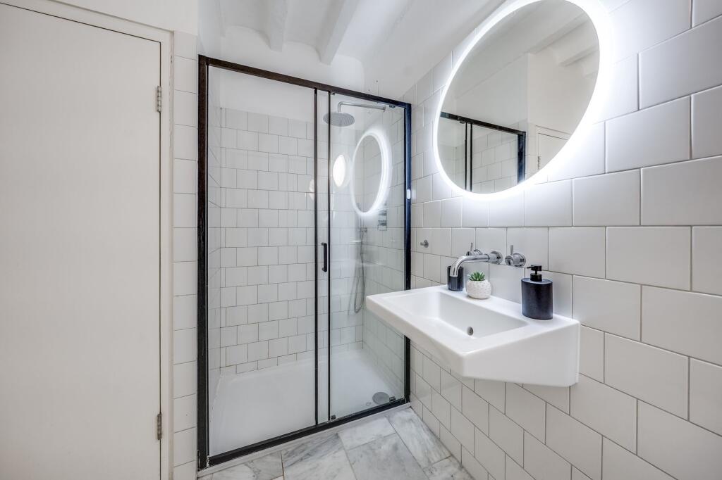 Modern bathroom featuring a spacious glass show...