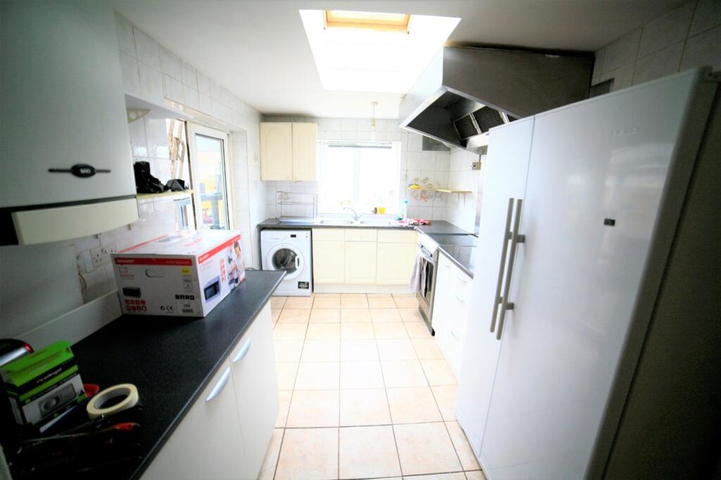 A bright and modern kitchen featuring ample cou...