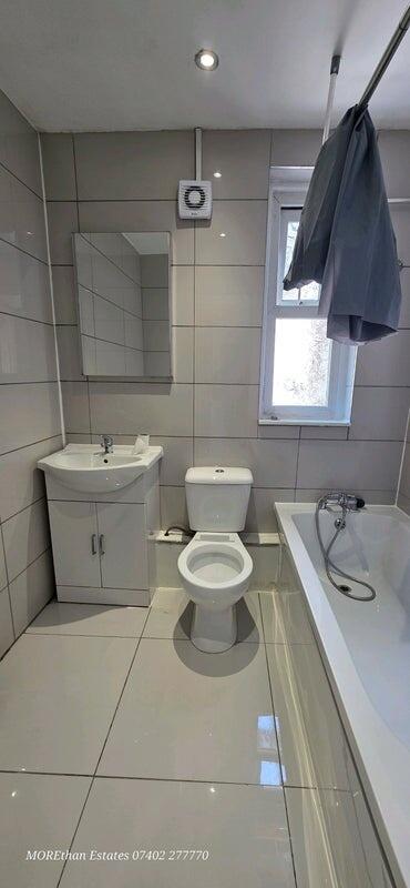 A modern and tidy bathroom featuring a sleek wh...