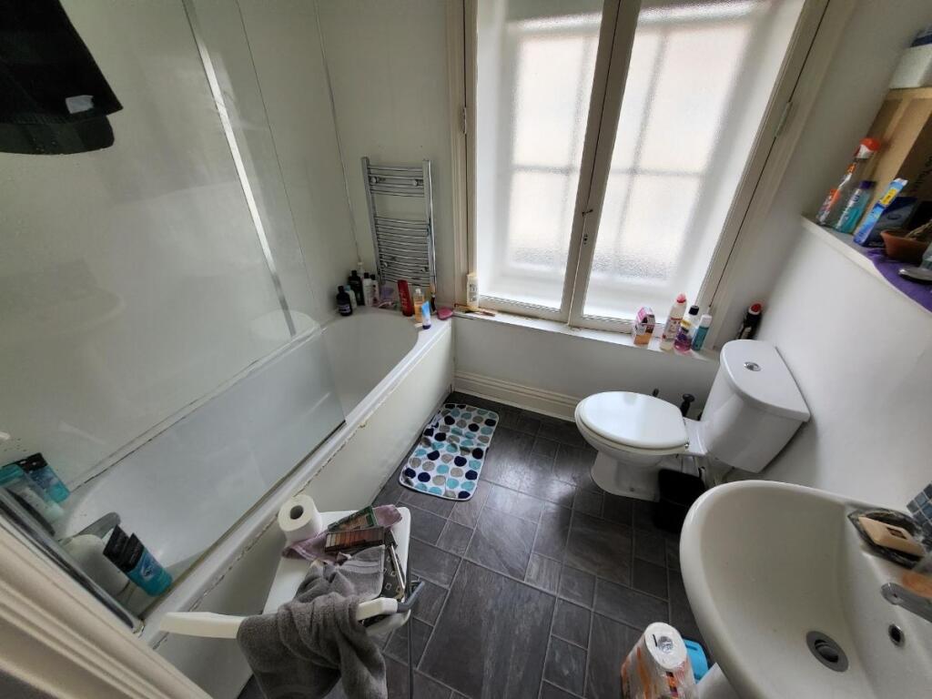 Bright and functional bathroom featuring a bath...