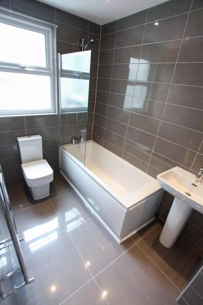 A modern, well-maintained bathroom featuring sl...