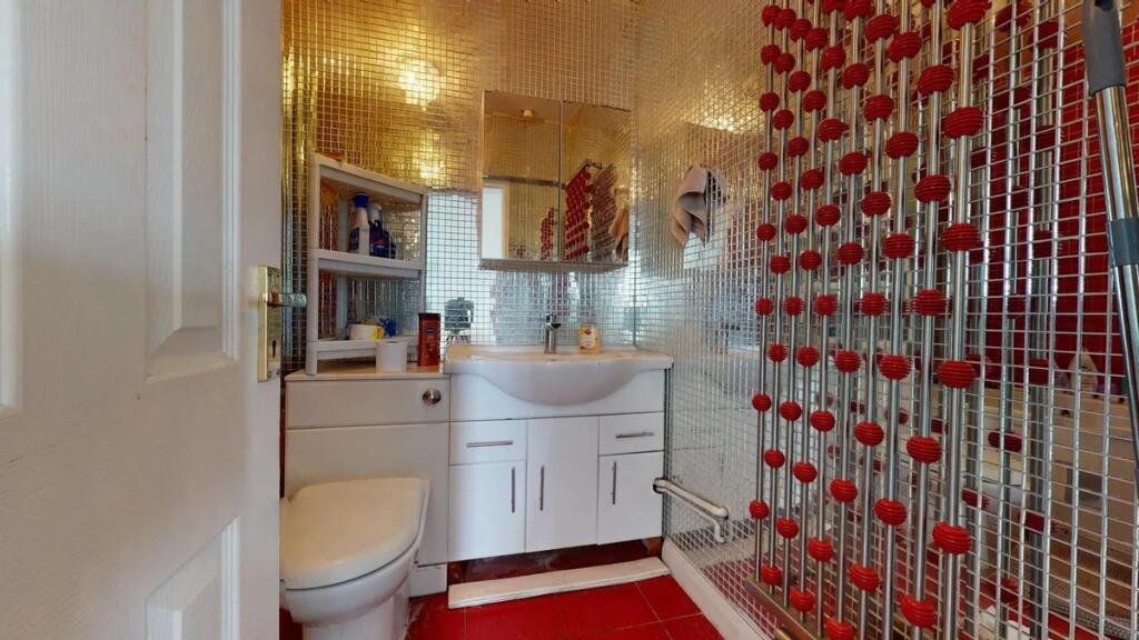 Bright and modern bathroom featuring reflective...