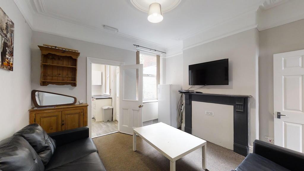 A cozy living room featuring a comfortable blac...