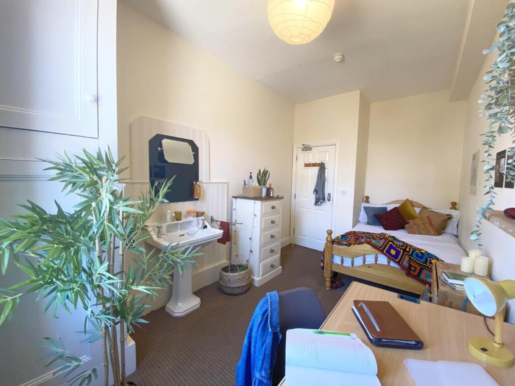 Bright, well-kept bedroom with a double bed, st...