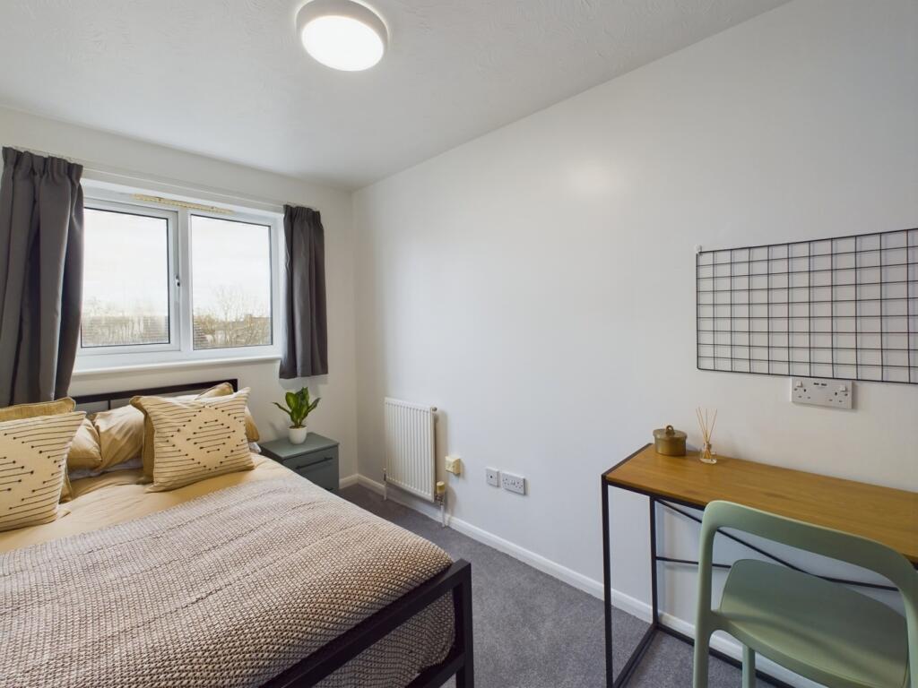 A bright and stylish double bedroom featuring m...