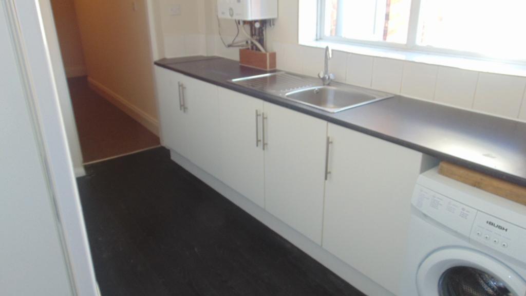 Bright kitchen with ample counter space, white ...