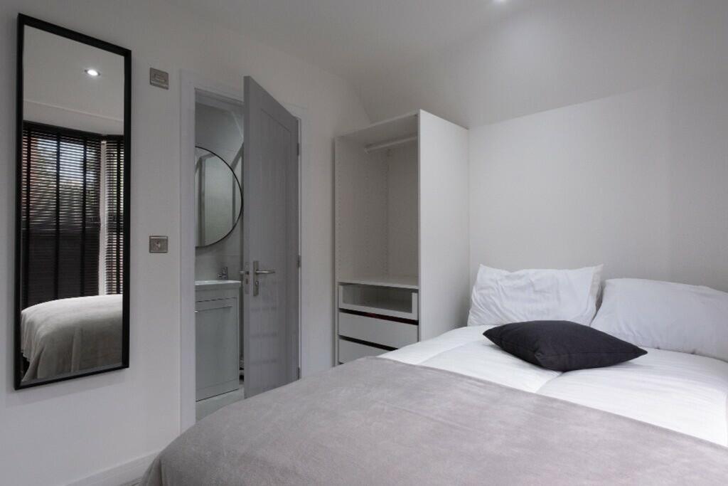 This inviting double bedroom features a comfort...