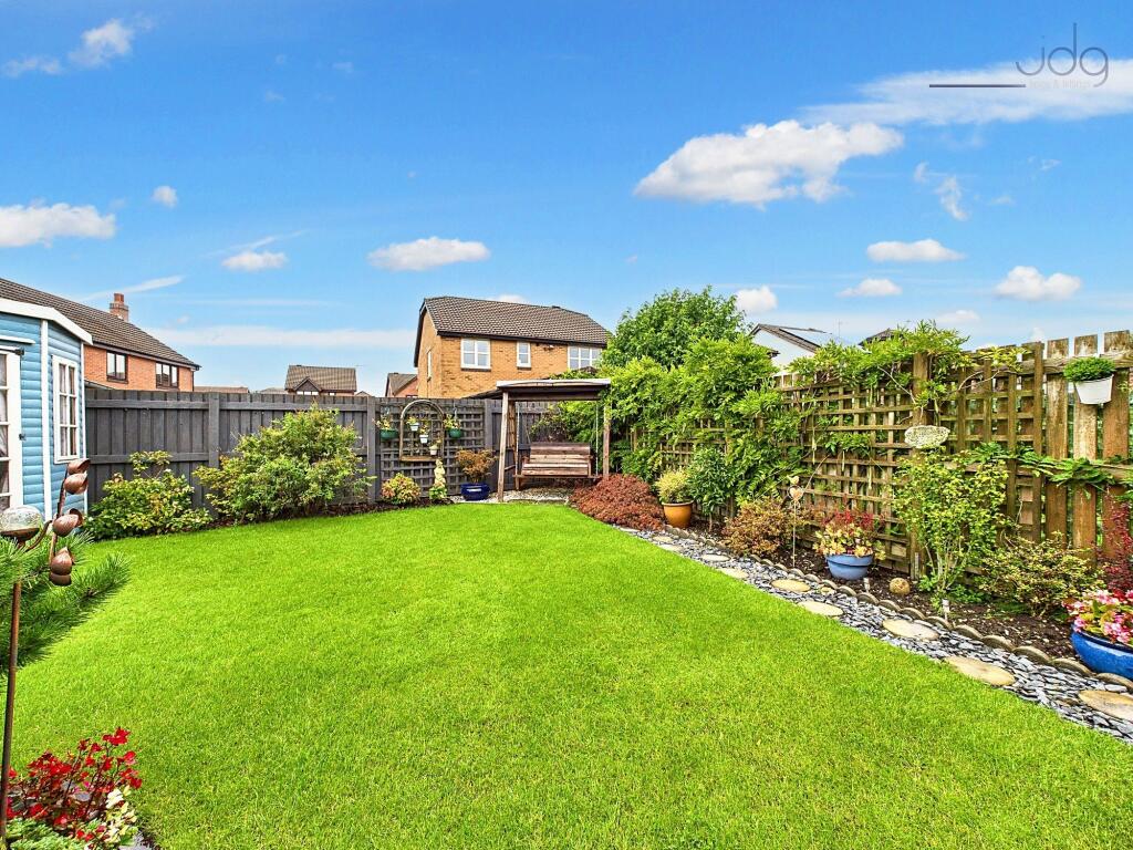 Northwest Garden with summer house and a mixture of lawn and flags