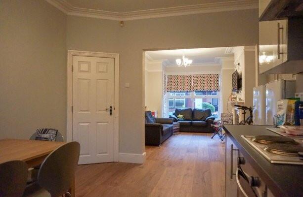 A spacious, bright living room with large windo...