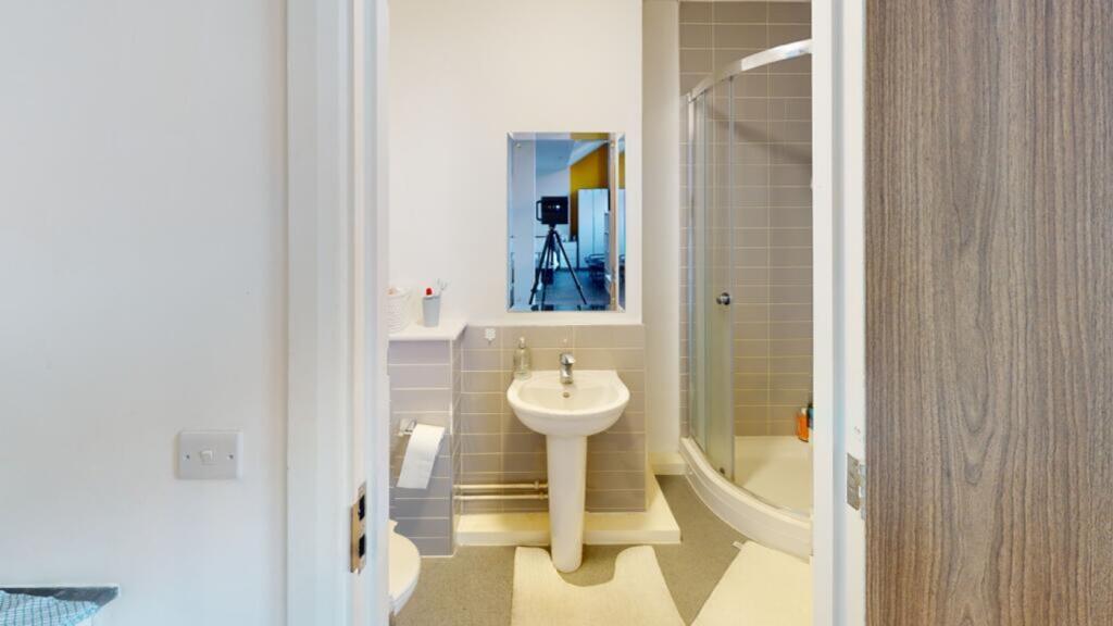 A modern bathroom featuring a sleek shower, sty...
