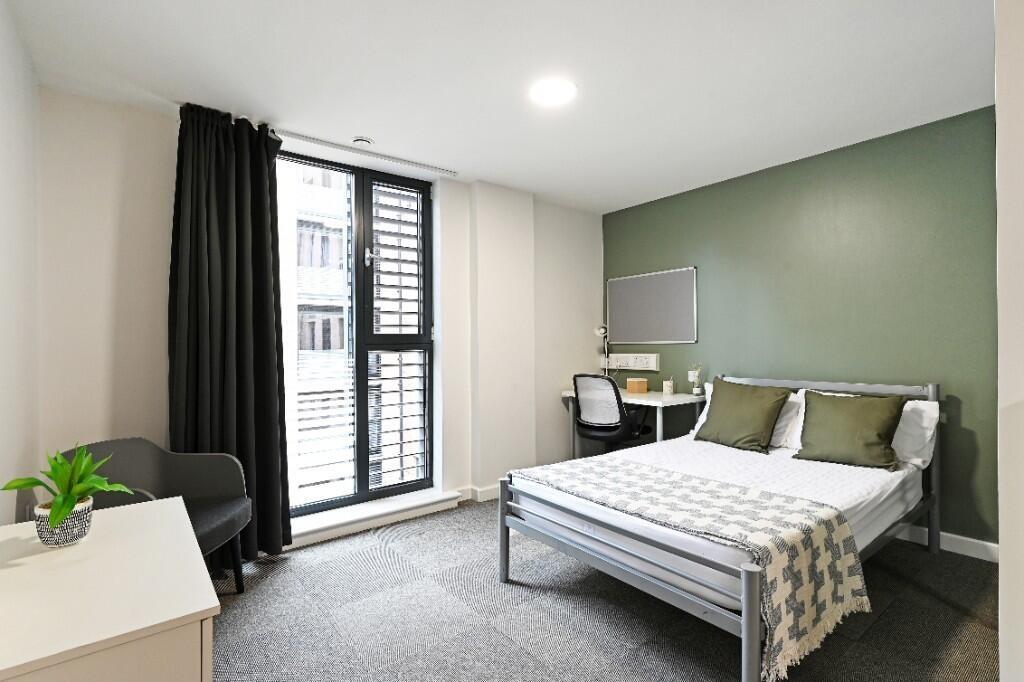 A modern double bedroom featuring a comfortable...
