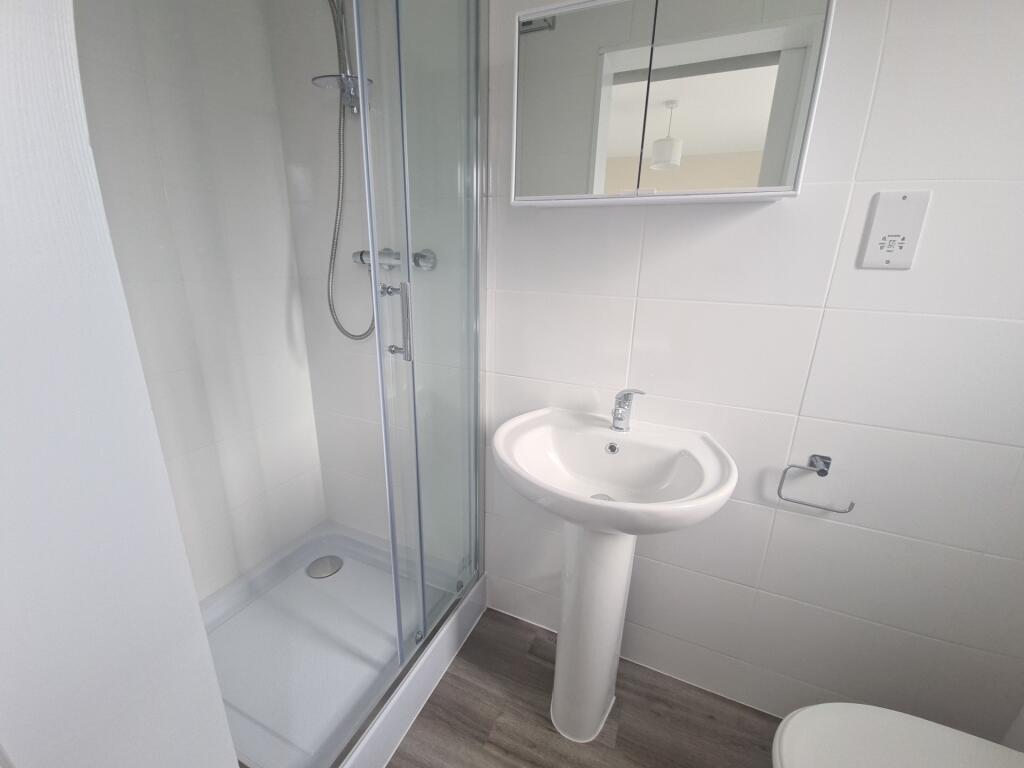 Bright and clean bathroom featuring a modern pe...