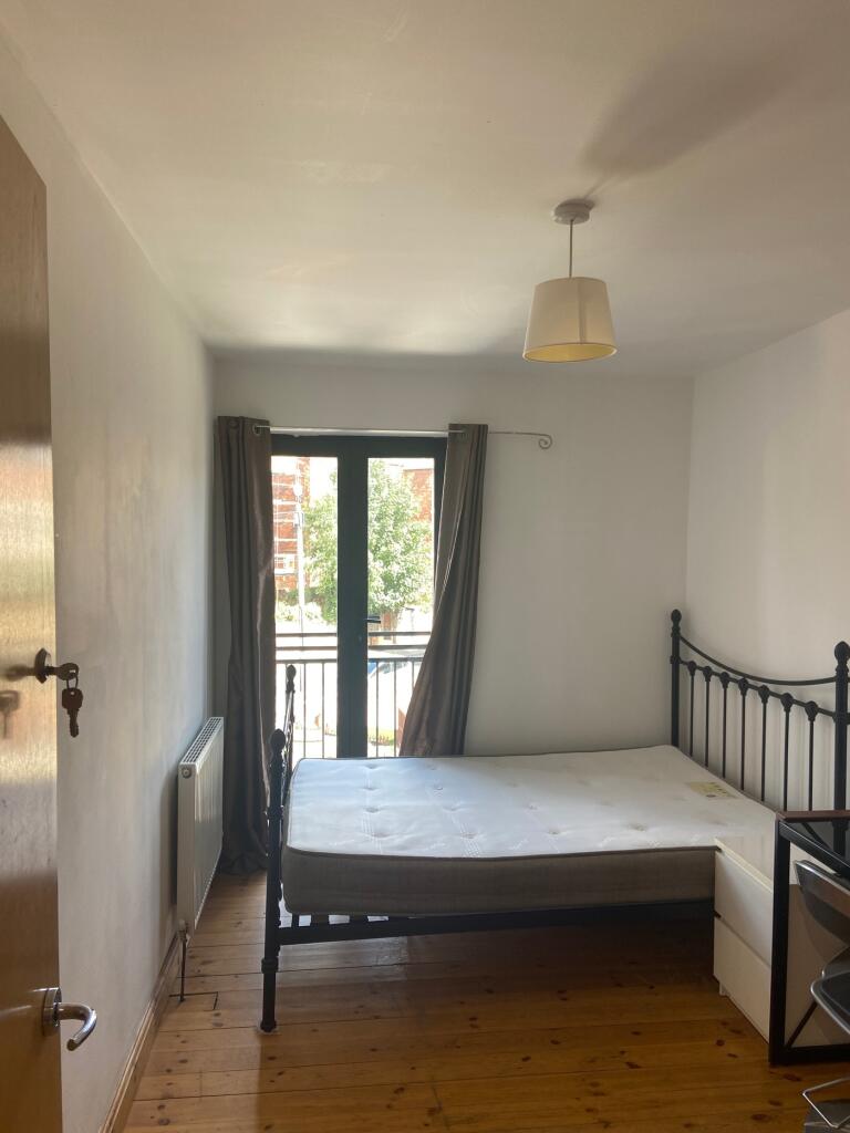 A tidy and well-lit double bedroom featuring a ...