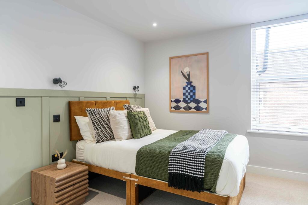 A spacious and stylish master bedroom featuring...