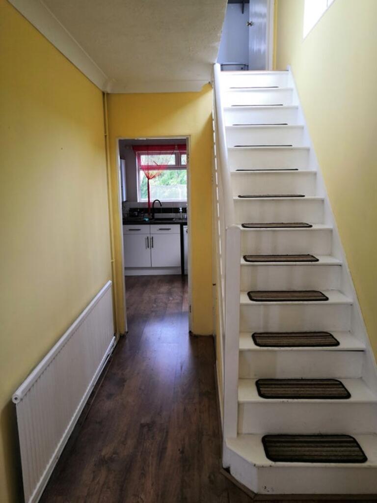Bright and inviting hallway with a warm yellow ...