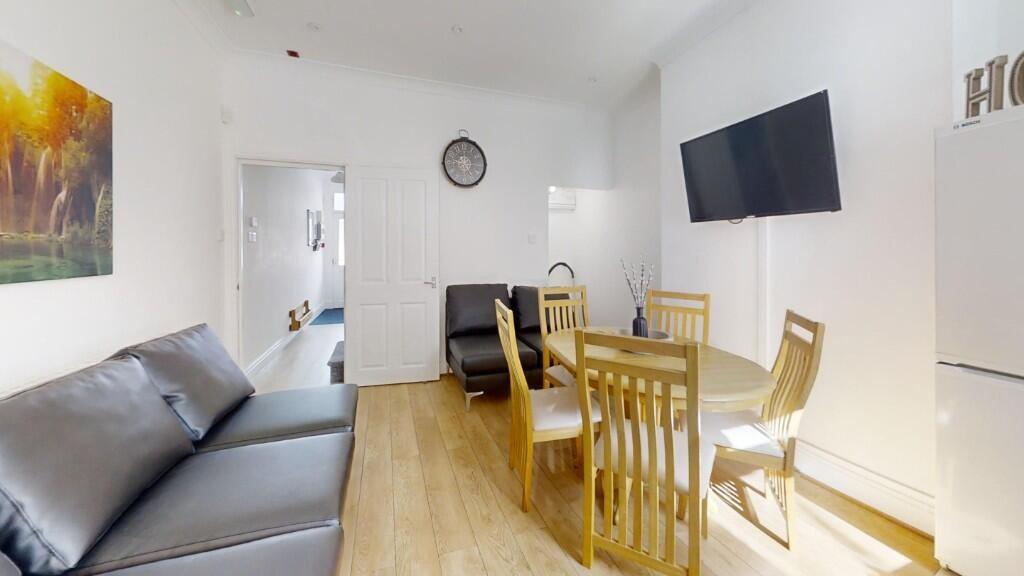 Bright and modern living room featuring a woode...