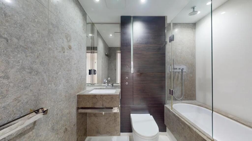 A modern and sleek bathroom suite featuring a c...