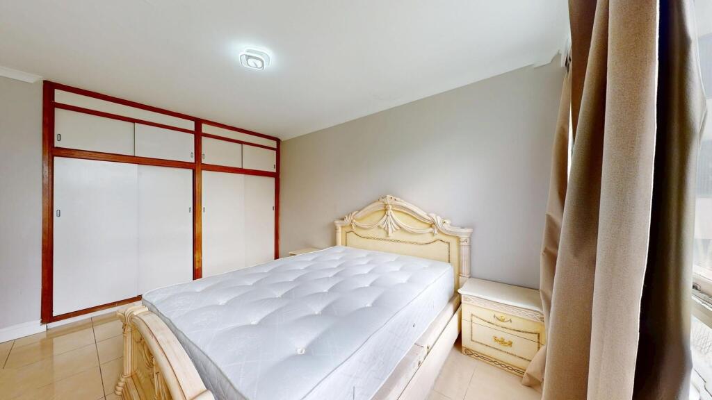 A spacious master bedroom featuring a large, or...