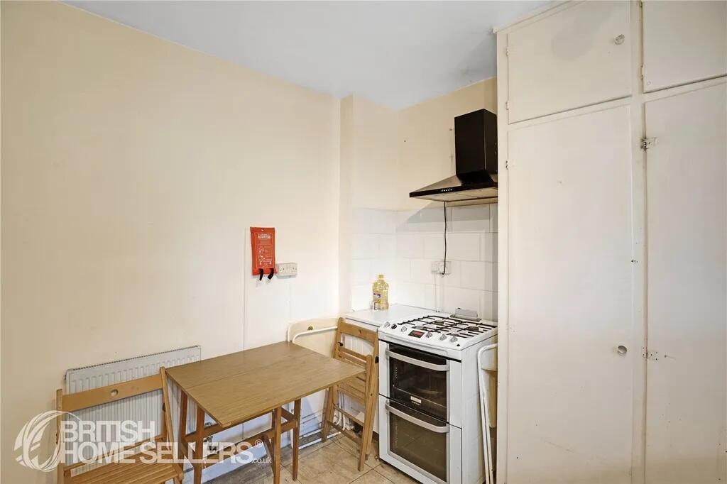 A compact kitchen featuring a gas stove with ov...
