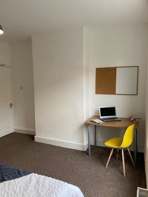 This cozy double bedroom features a comfortable...