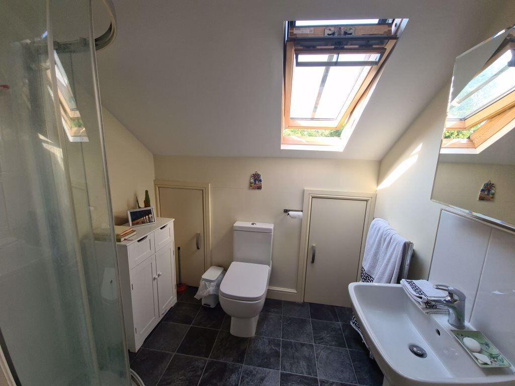 A bright and clean bathroom with a modern toile...