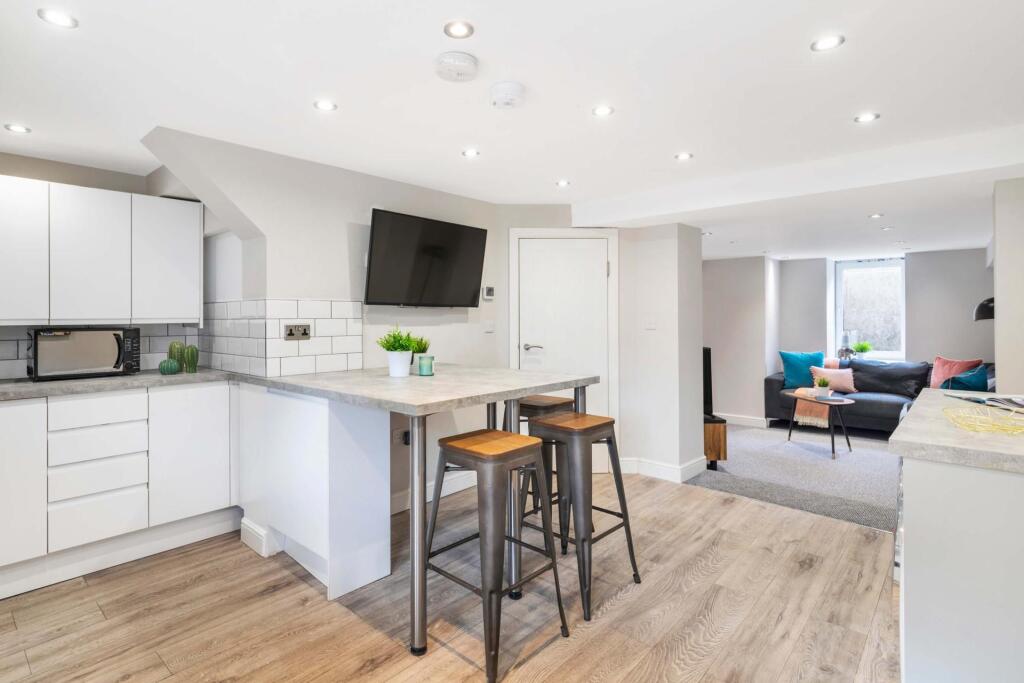 A modern, bright living room featuring a large ...