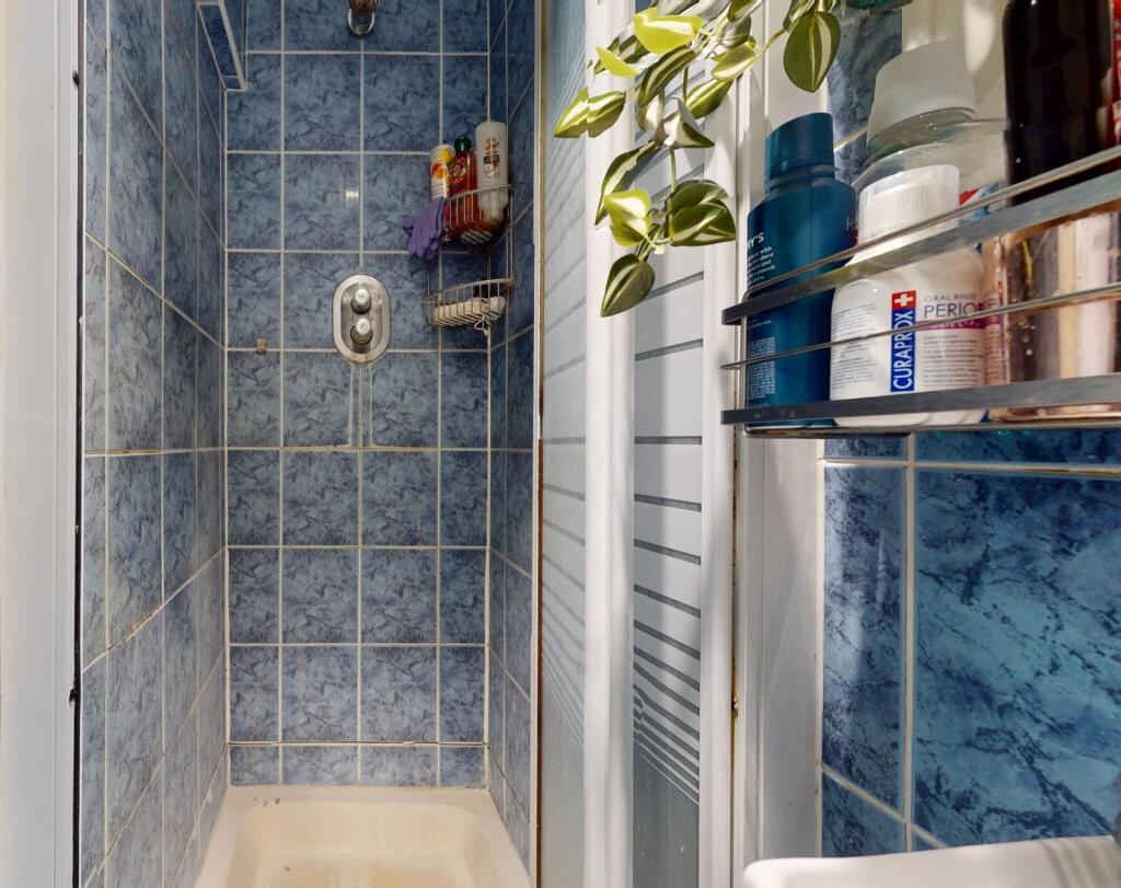 A clean and bright bathroom featuring a spaciou...