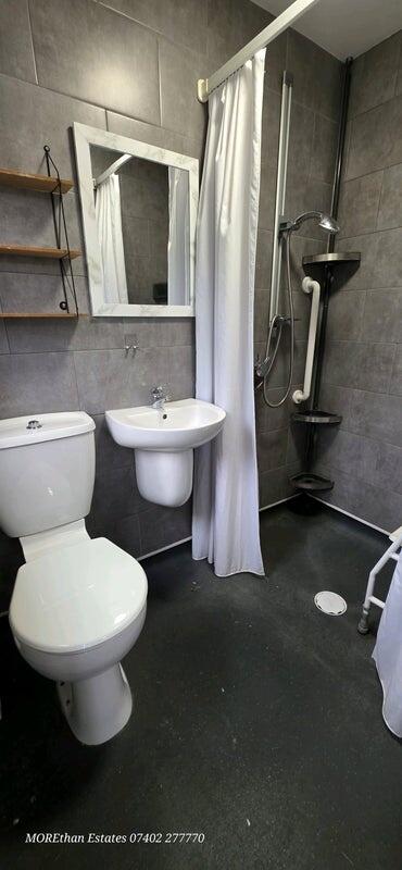A modern and tidy bathroom featuring a compact ...