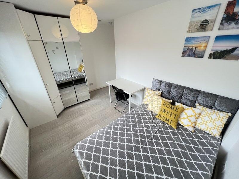 Bright and cozy double bedroom featuring a comf...