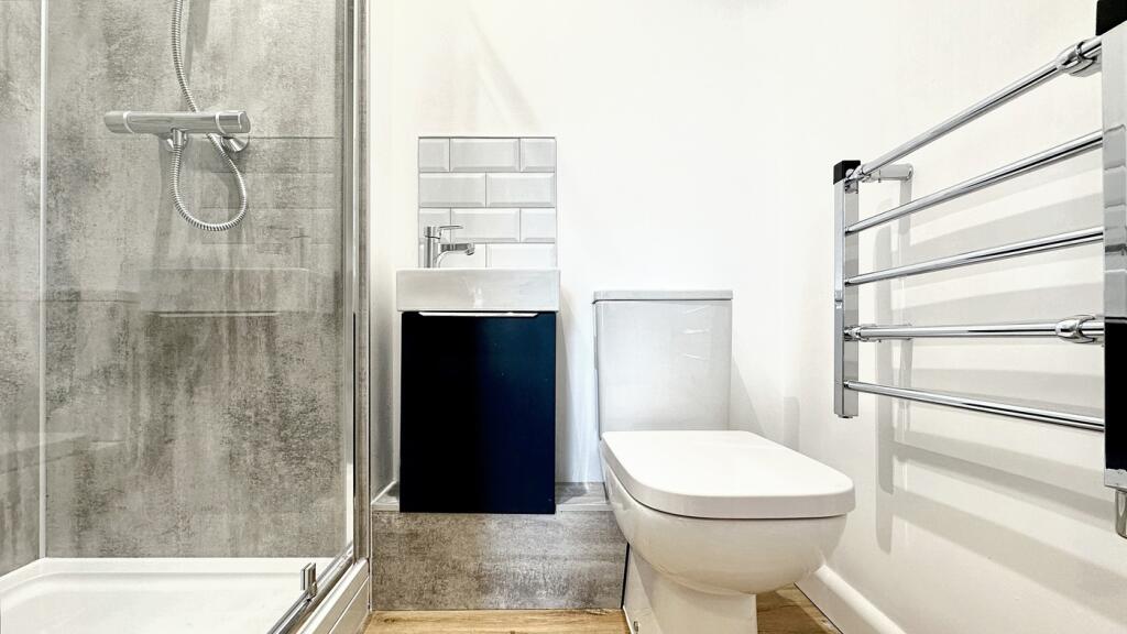 A modern bathroom featuring a sleek shower, sty...