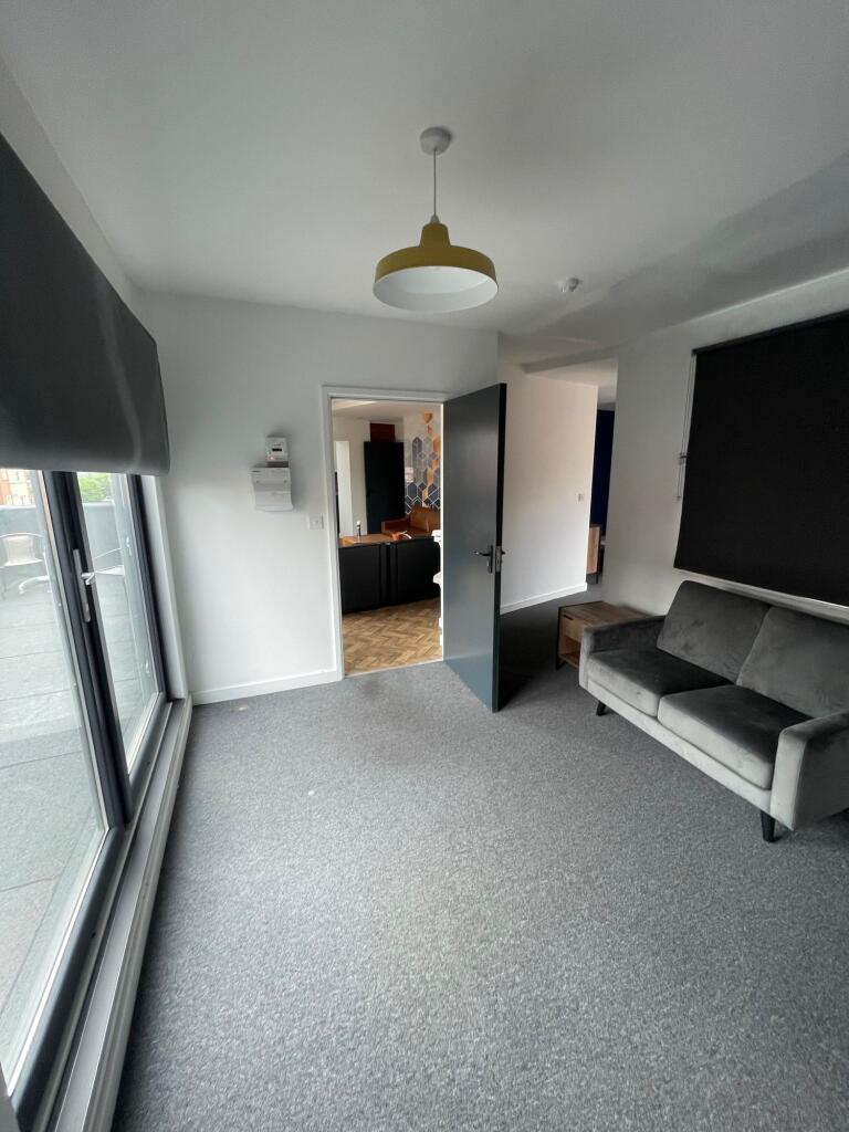 Bright and inviting living room featuring large...