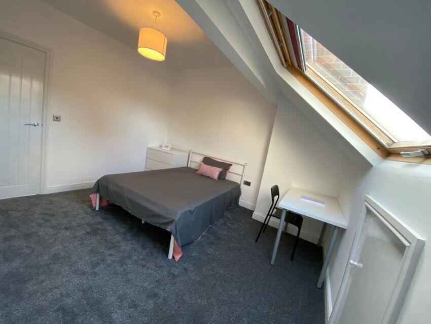 A bright and spacious attic master bedroom feat...